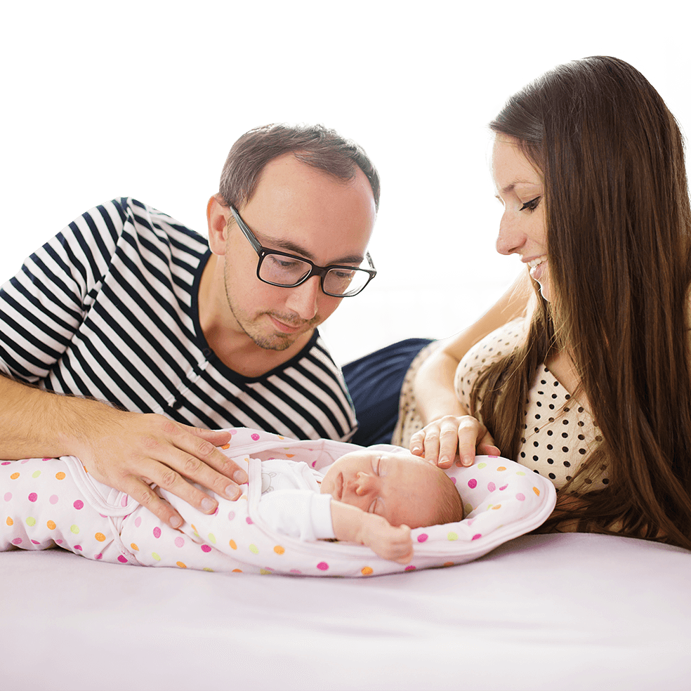 graphicstock-happy-young-parents-with-their-newborn-baby-girl-at-home_H0XGva83bZ